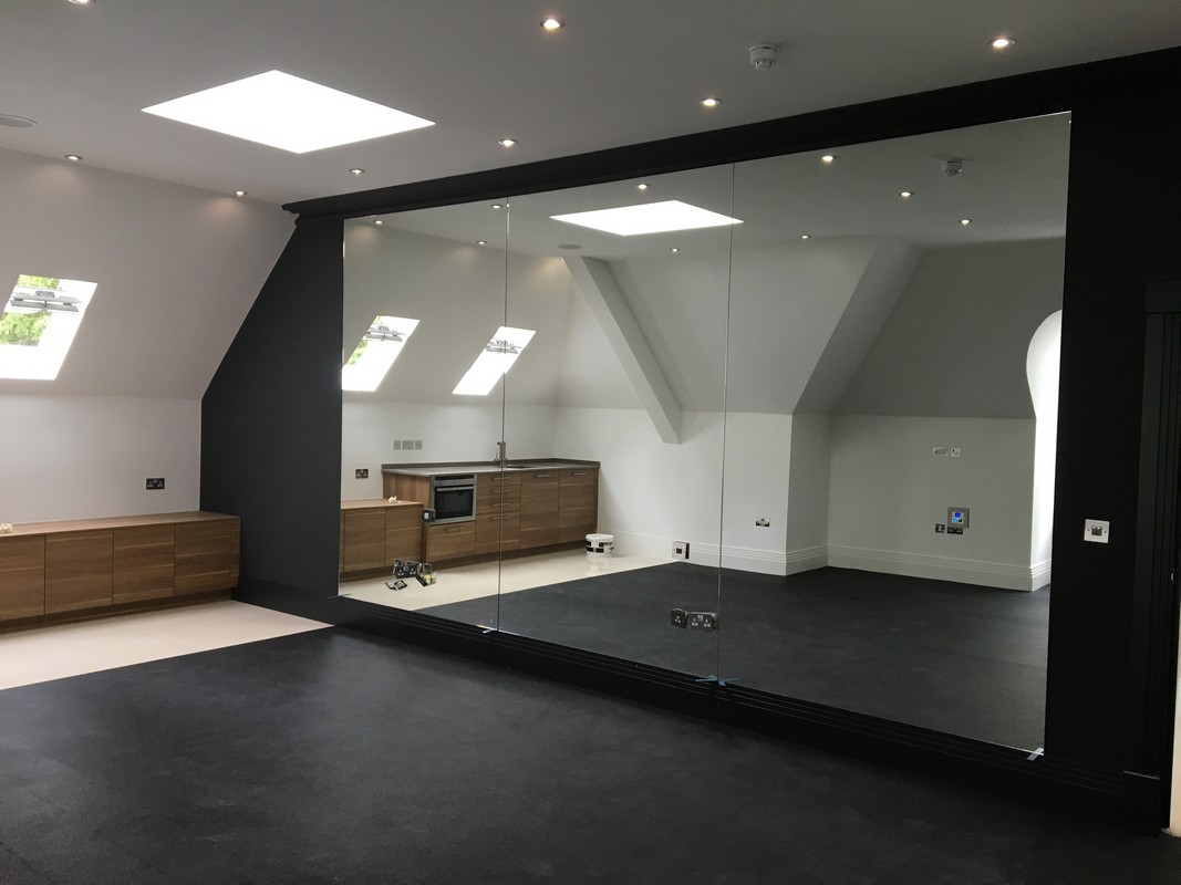 Frameless glass wall dividing loft conversion in Didcot